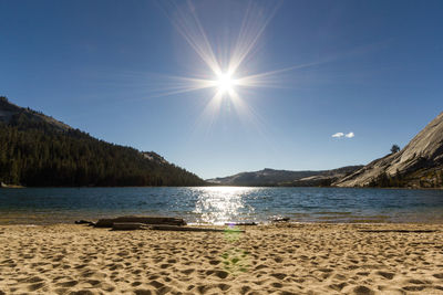 Scenic view of sea against bright sun