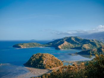 Scenic view of sea and mountains against sky