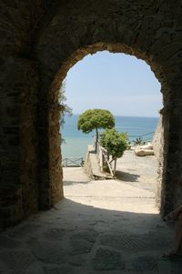 Ocean view through tunnel in mediterranean village