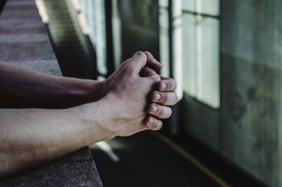 Cropped hands on wall