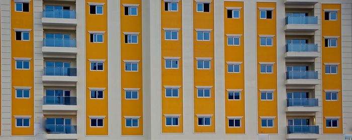 Full frame shot of yellow apartment building