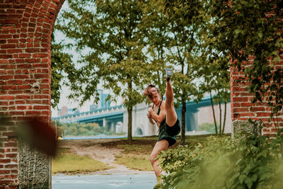 Young woman exercising outdoors in park.