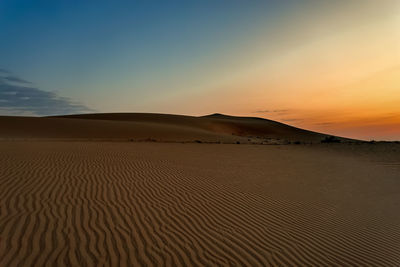 Scenic view of desert against sky during sunset