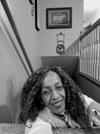 Portrait of woman with curly hair at home