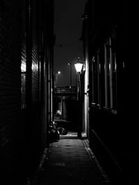 Street amidst buildings at night