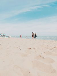 People on beach against sky