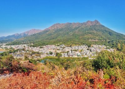 Scenic view of townscape against clear blue sky