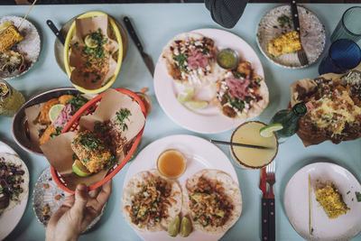 Directly above view of fresh street snacks and cocktail on table at restaurant