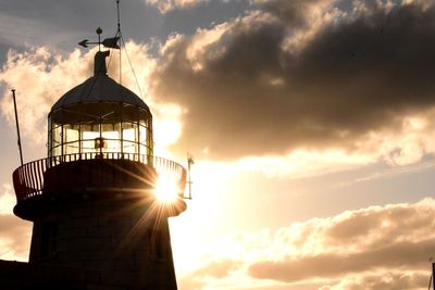 Low angle view of silhouette tower against sky during sunset