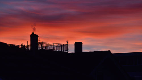 Silhouette of building against dramatic sky