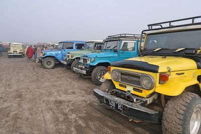 Vehicles parked on road against clear sky