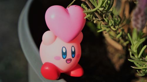 High angle view of heart shape with pink toy