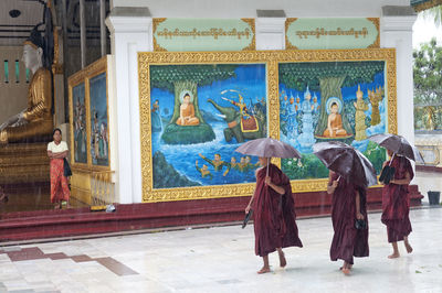 Rear view of women walking in temple