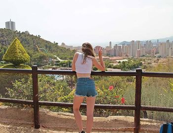 Man standing on railing