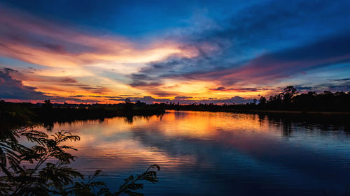 Scenic view of lake against orange sky