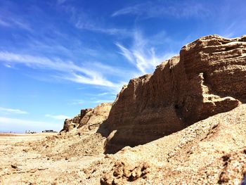 View of rock formations on landscape against sky