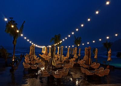 Low angle view of illuminated buildings against sky at night