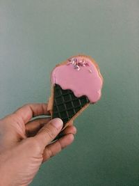 Close-up of hand holding ice cream cone