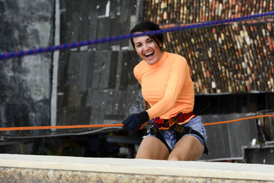 A female rappellist descending the elevator lacerates. very tall monument. salvador bahia brazil.