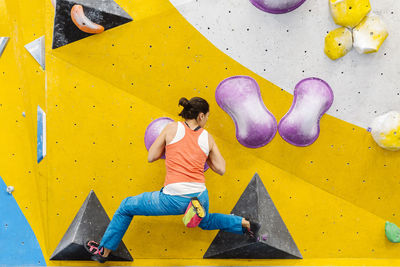 Woman climbing on wall