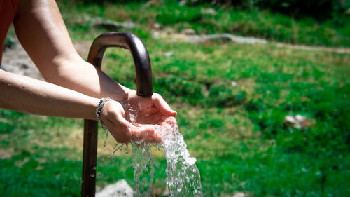 Low section of person washing hands