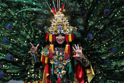 Portrait of smiling young man standing in traditional clothing