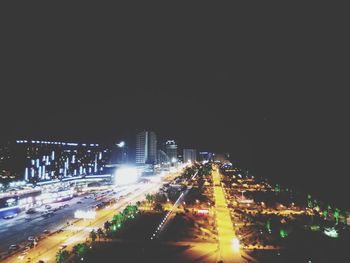 High angle view of illuminated street and buildings at night