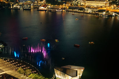 High angle view of illuminated buildings in water