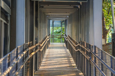 Footbridge over footpath amidst buildings