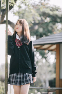 Portrait of a beautiful young woman standing outdoors