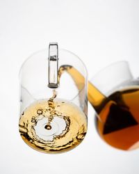 Close-up of wine glass against white background