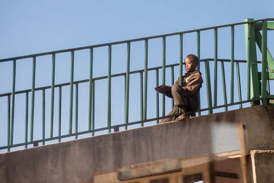 Low angle view of woman standing on steps