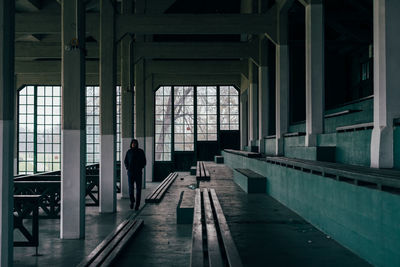 Young man walking in old building