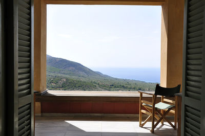 Scenic view of mountains and sea seen through balcony