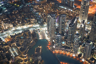 High angle view of city lit up at night