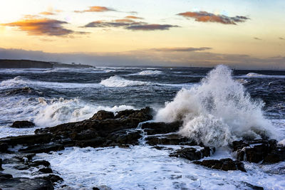 Waves crash on the rocks off the coast of whitley bay