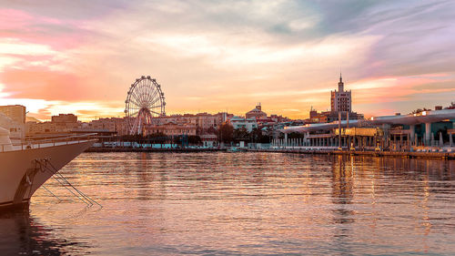 View of city at waterfront during sunset