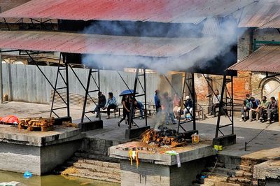 People working with fire in water