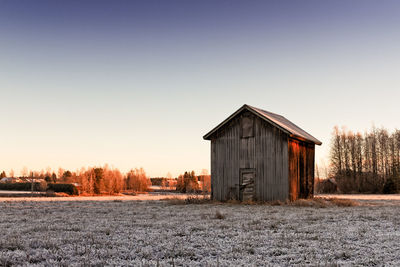 Small barn house in the winter sunrise