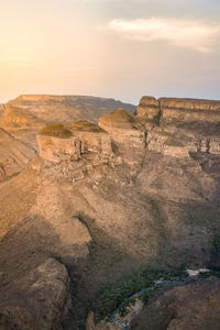 Rock formations on landscape against sky