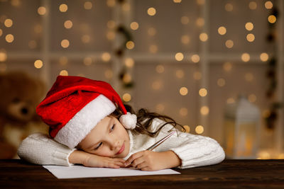 Portrait of cute baby boy lying on table