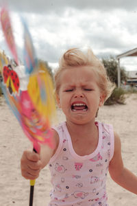 Portrait of girl playing with sand