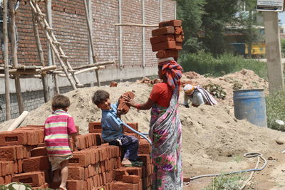 Rear view of people against building