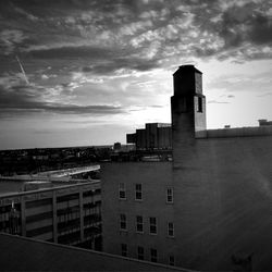 View of cityscape against cloudy sky