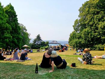 Group of people relaxing on field