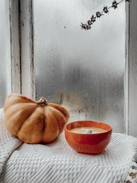 Close-up of orange fruits on table against window
