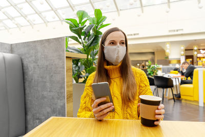 Man holding smart phone on table