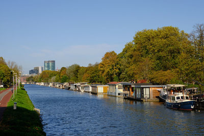 Utrecht, the netherlands. boats moored along the vaartse rijn canal with city in the distance.