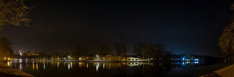 Illuminated trees against sky at night