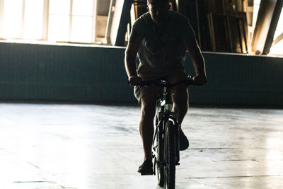 Man riding bicycle in building